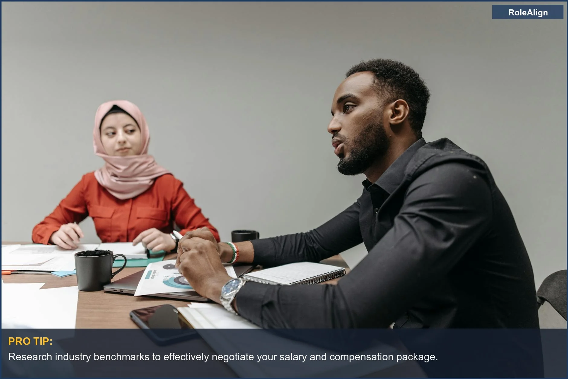 Business meeting with a diverse team discussing strategy at an office table.