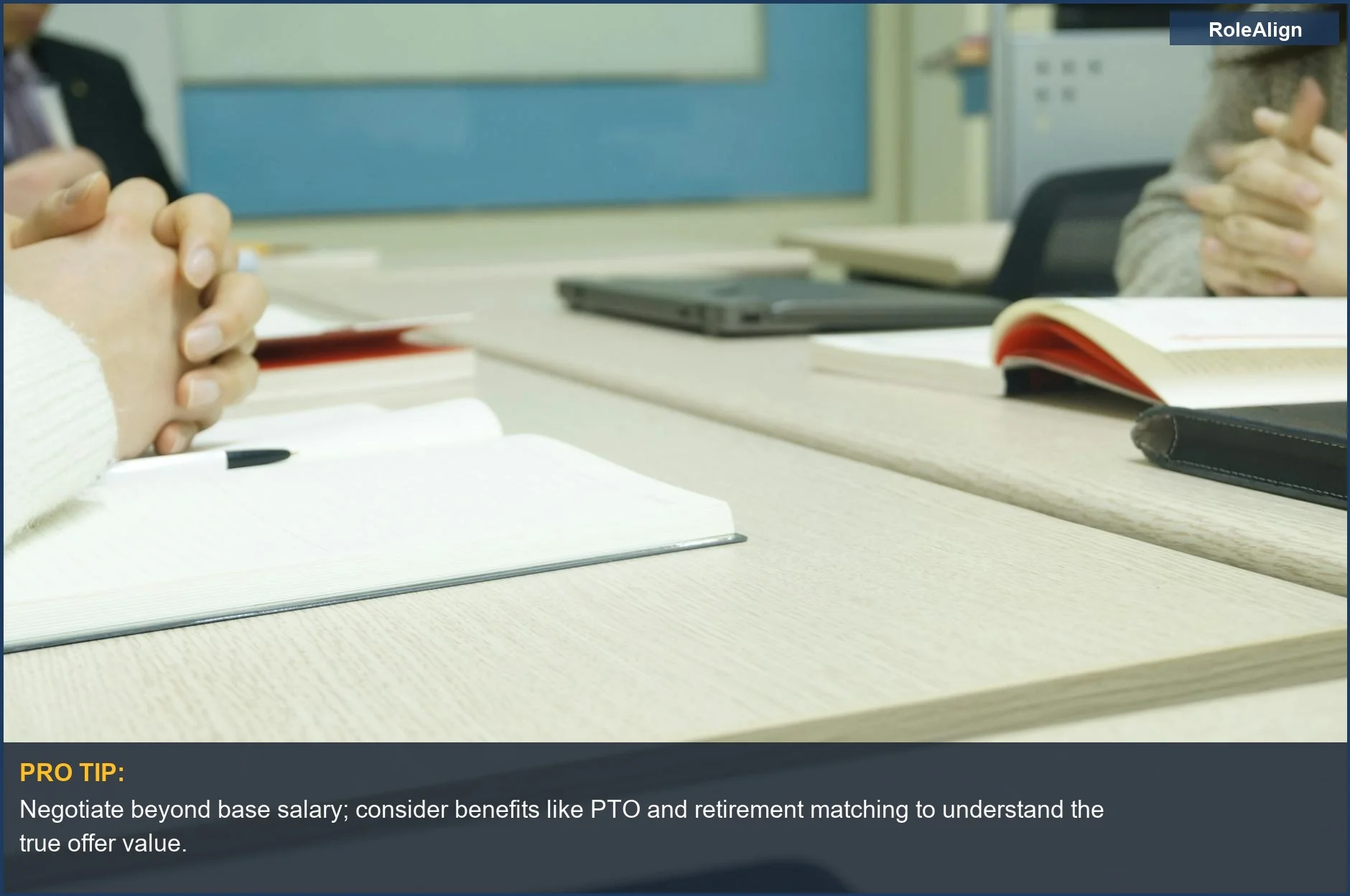 Professional meeting setup with hands, laptops, and notebooks, symbolizing the hidden costs of a dream job offer.