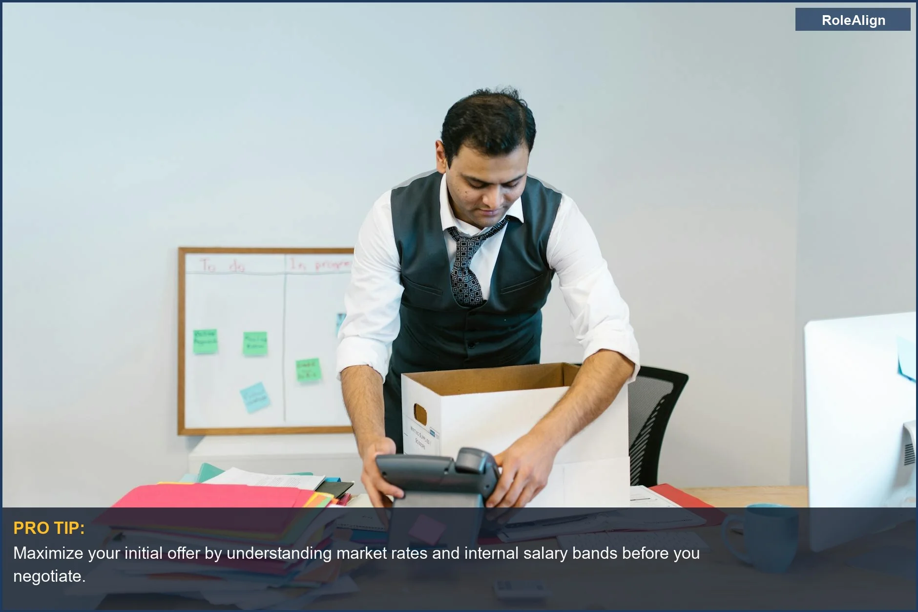 Man sadly packing office desk, highlighting the long-term career trajectory cost of poor negotiation.