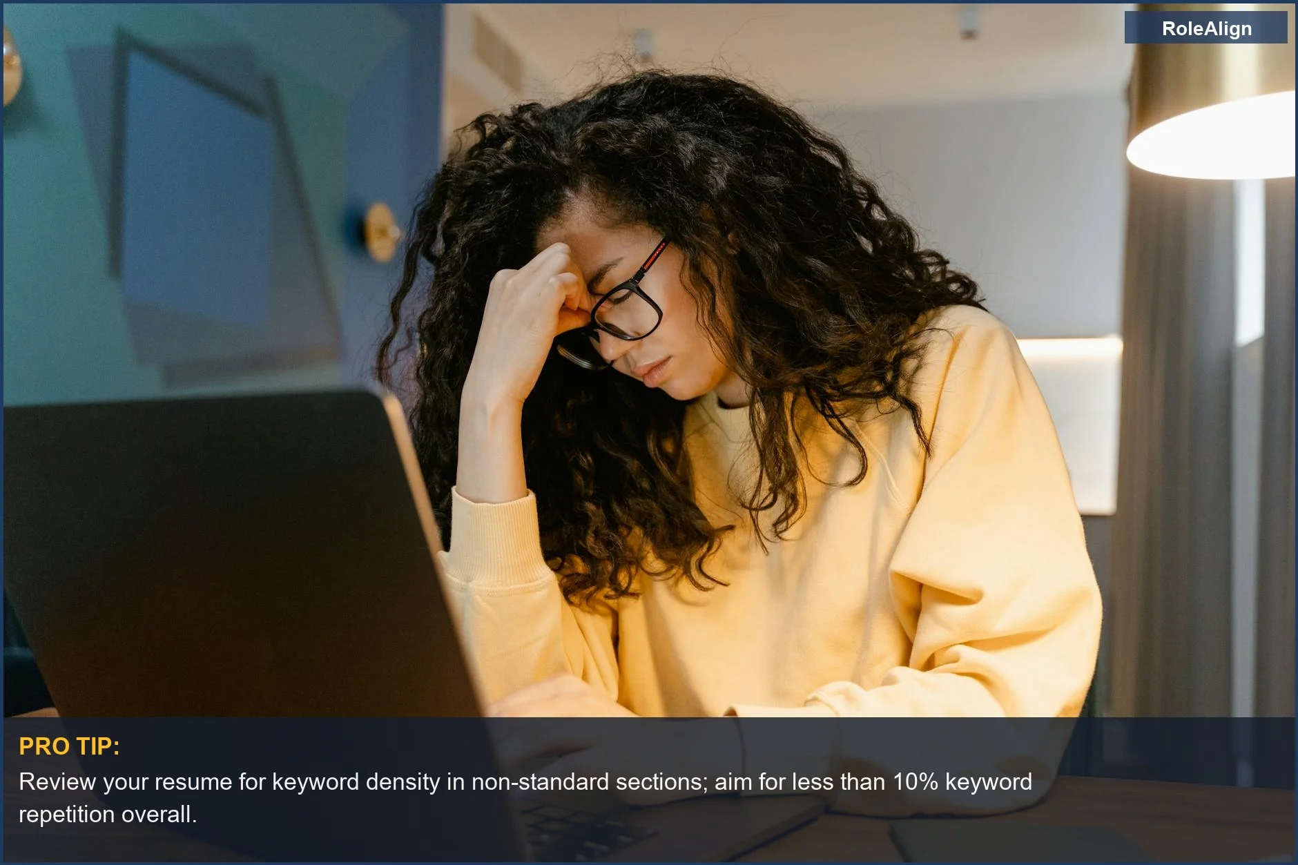 Tired woman with glasses stressed at laptop, a victim of AI resume keyword stuffing challenges.