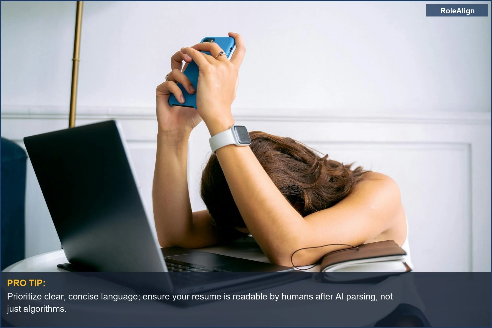 Woman overwhelmed by work, resting head on table, facing the pitfalls of AI resume optimization.