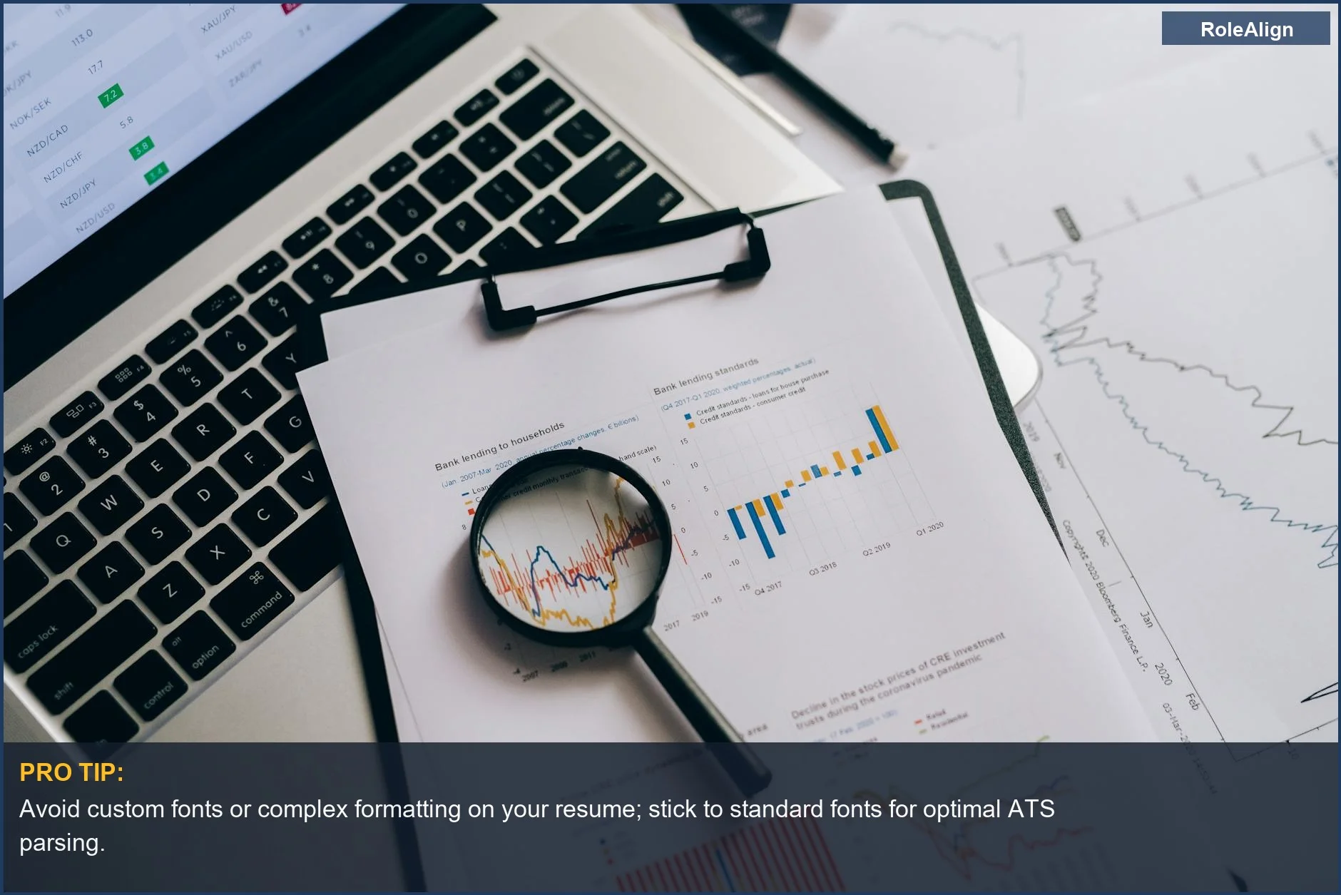 Overhead view of financial charts, laptop, and magnifying glass, representing ATS parsing challenges.