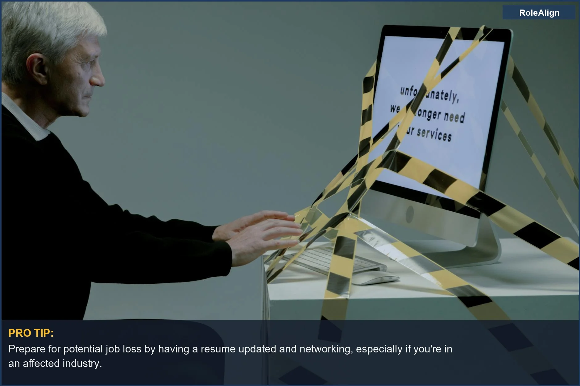 Elderly man facing unemployment after viewing a termination notice on his computer.