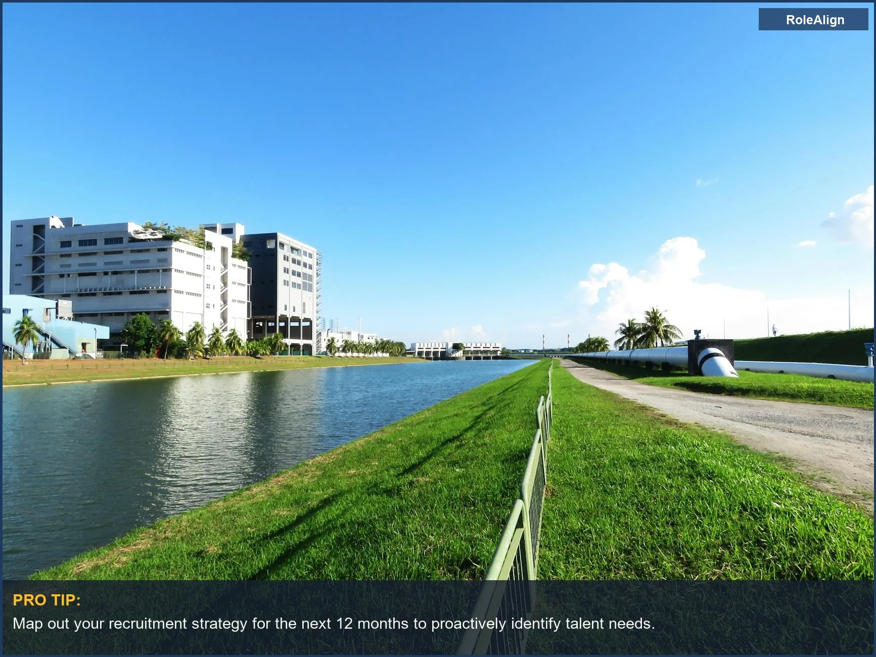 Modern industrial building by a canal, symbolizing the infrastructure needed for effective talent acquisition and hiring.