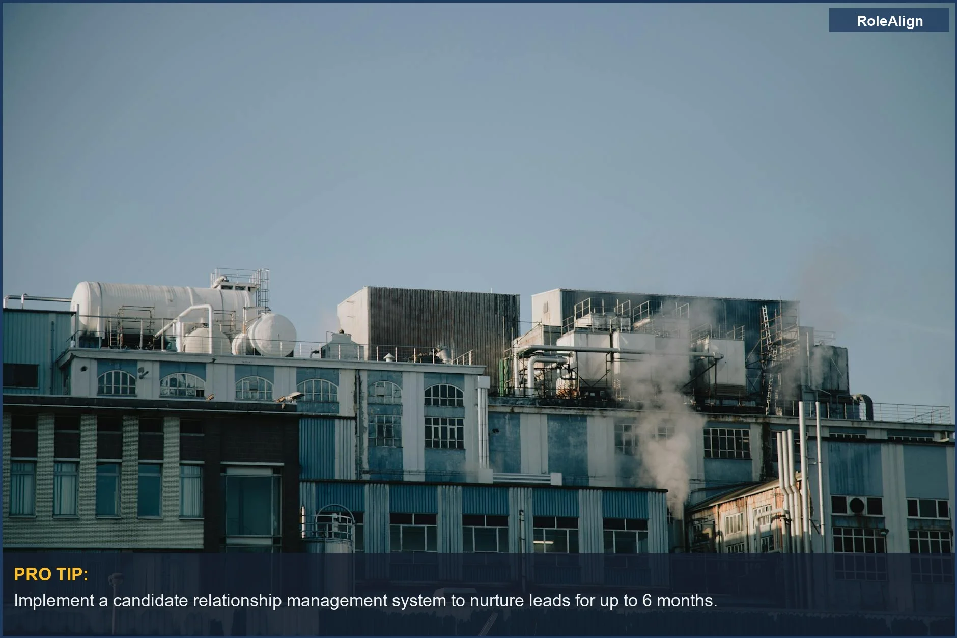 Large industrial building with smoke emissions, representing the active and ongoing nature of talent acquisition and recruiting efforts.