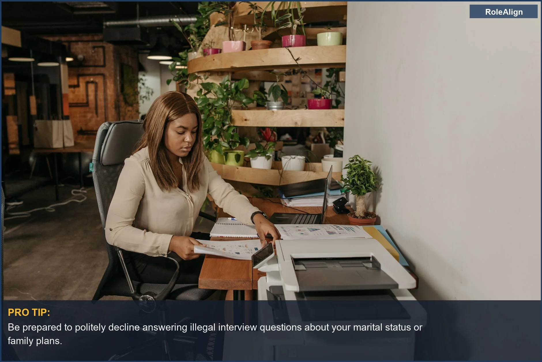 Focused woman in modern office environment, illustrating awareness of interview discrimination questions.