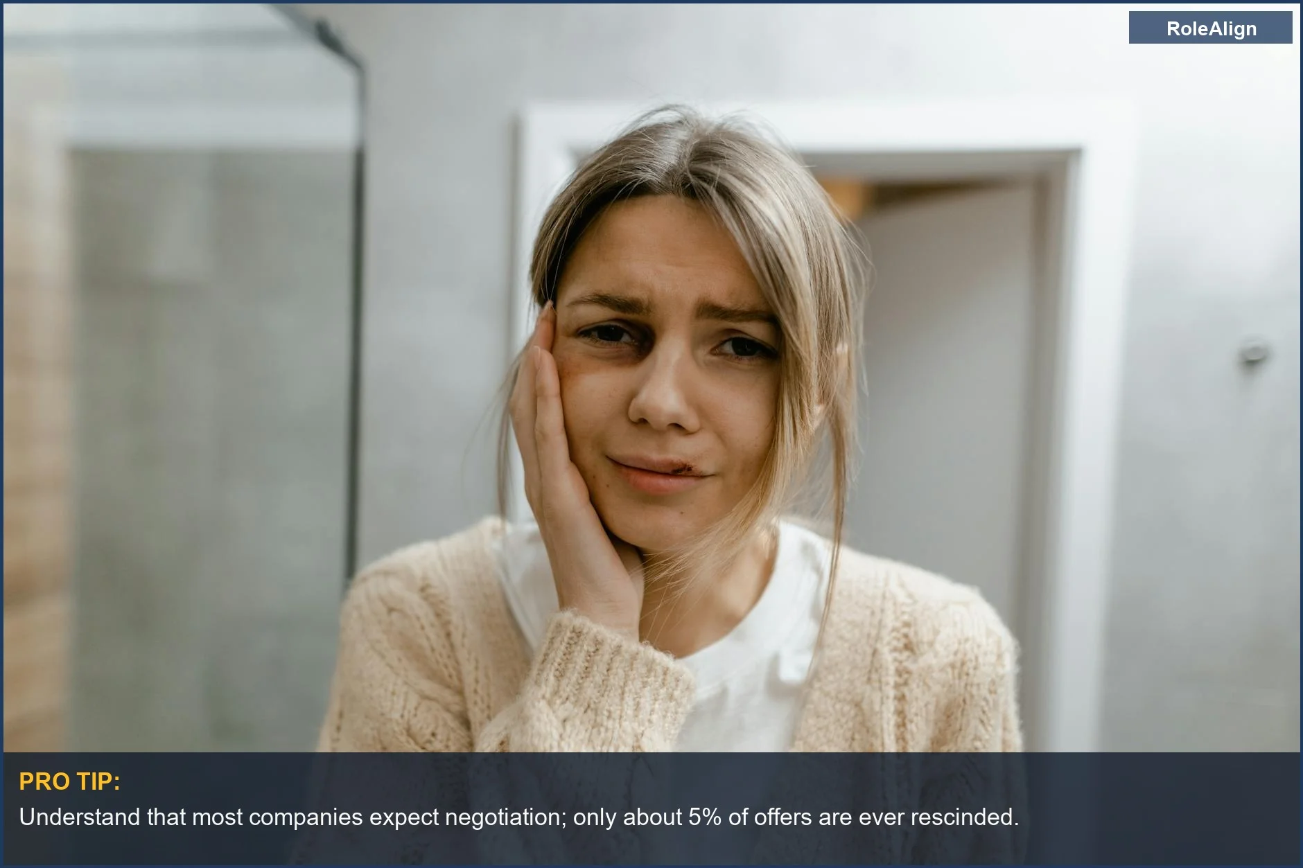 Worried woman touches face, contemplating the possibility of a rescinded offer negotiation after attempting to negotiate.