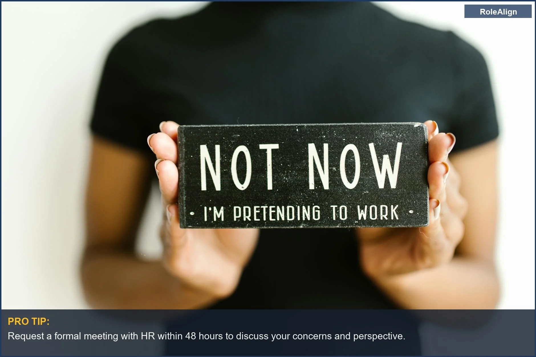 Woman holding a humorous office sign, symbolizing navigating complex workplace policies and employee write-up rights.