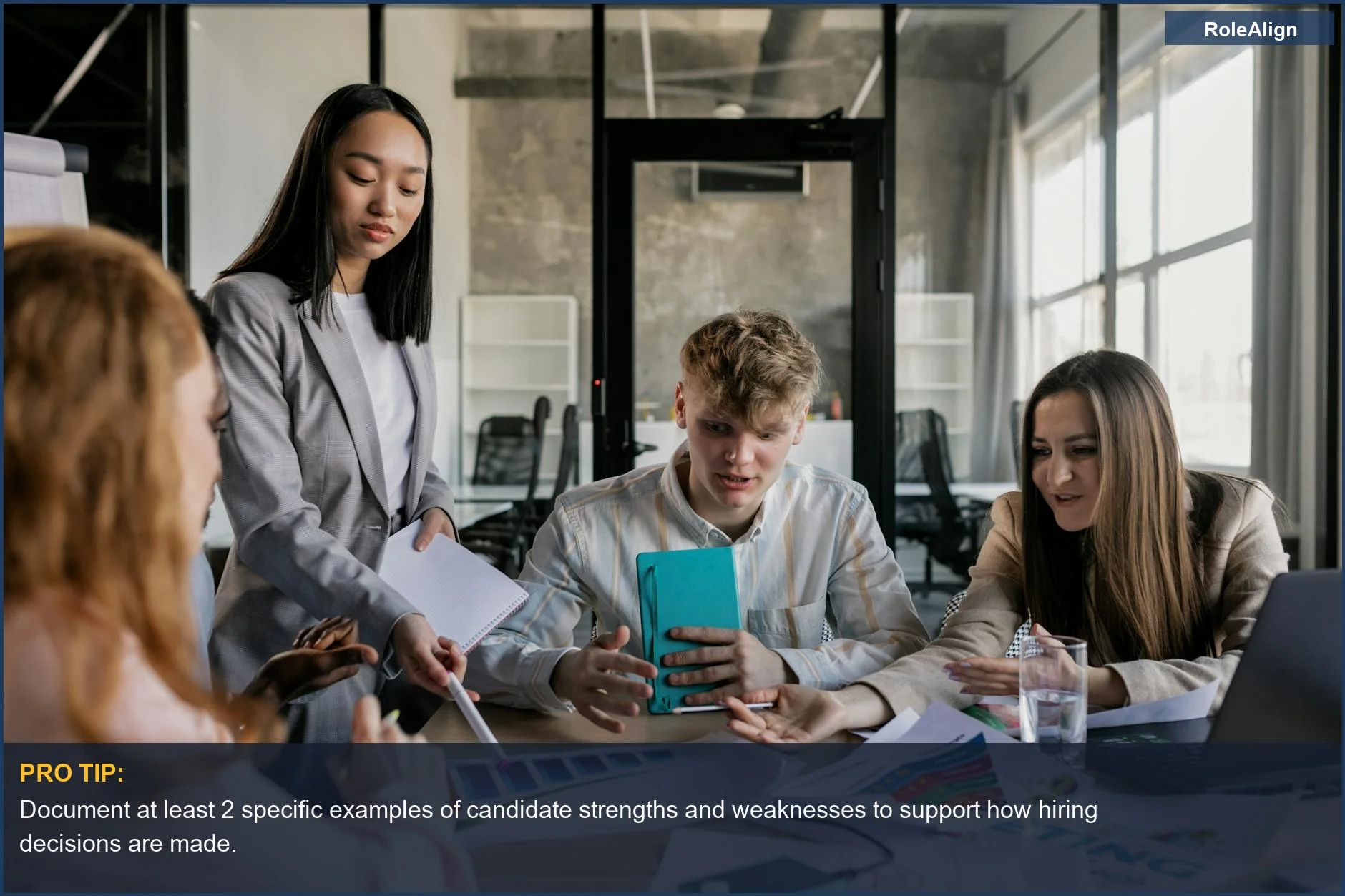 Colleagues having a lively discussion around a conference table, reflecting on candidate evaluations in how hiring decisions are made.