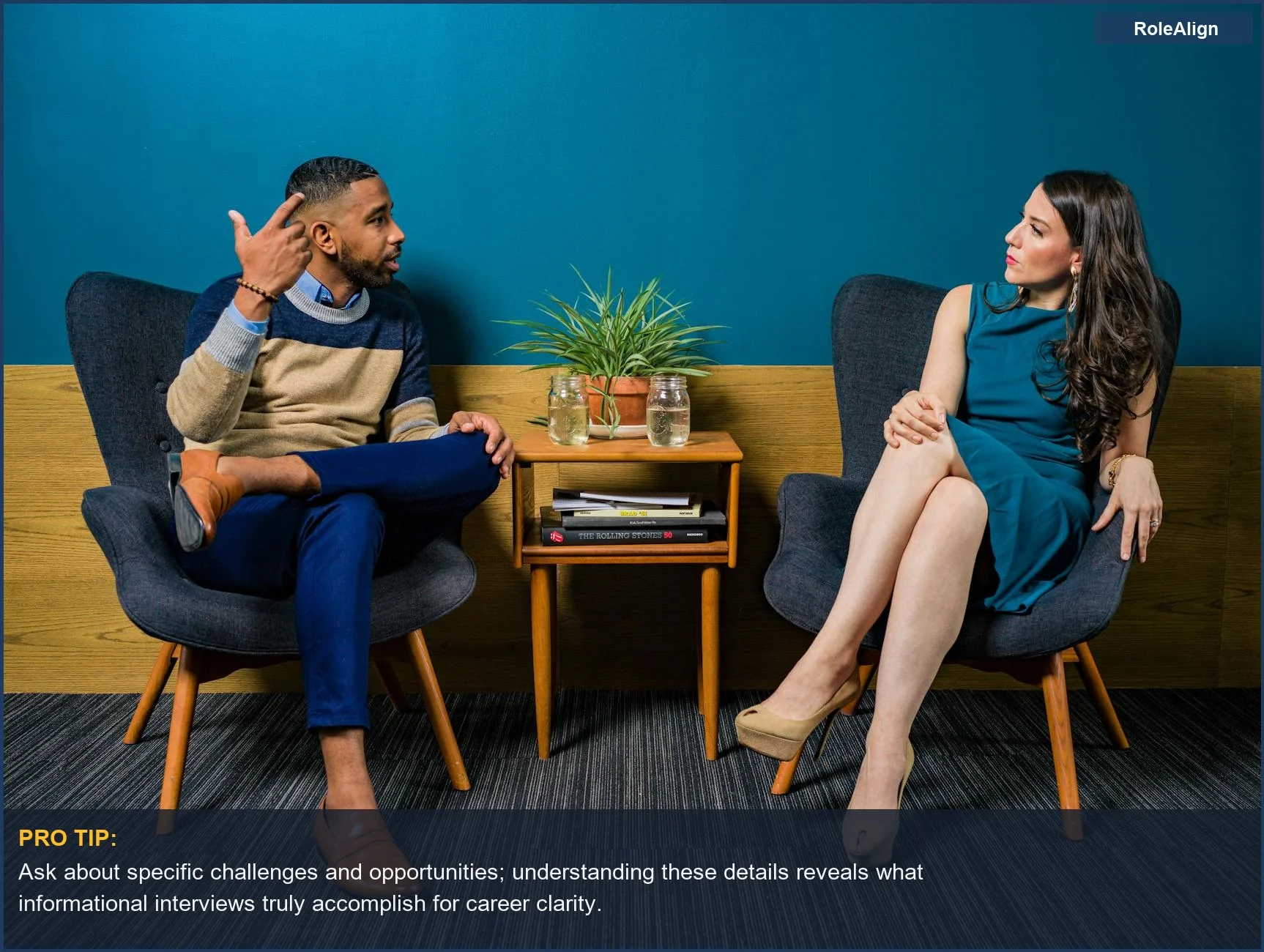 Two professionals in a modern room, deep in thoughtful discussion about career paths and FinTech.