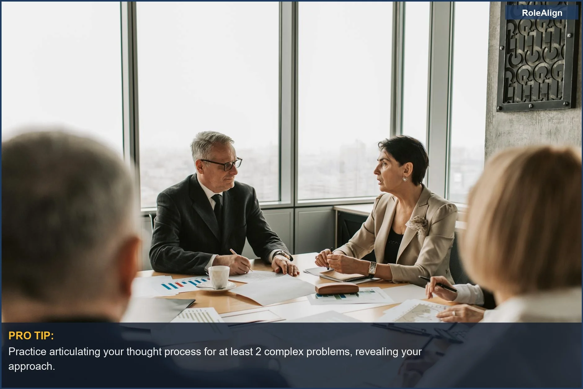Business professionals strategizing in a modern office, highlighting behavioral indicators interviewers seek.