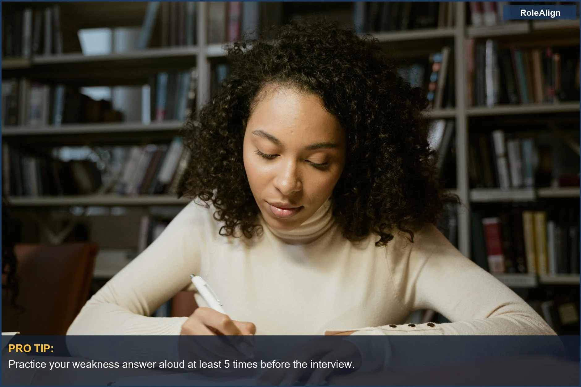 Determined young woman studying in a library, preparing for interview weakness questions.