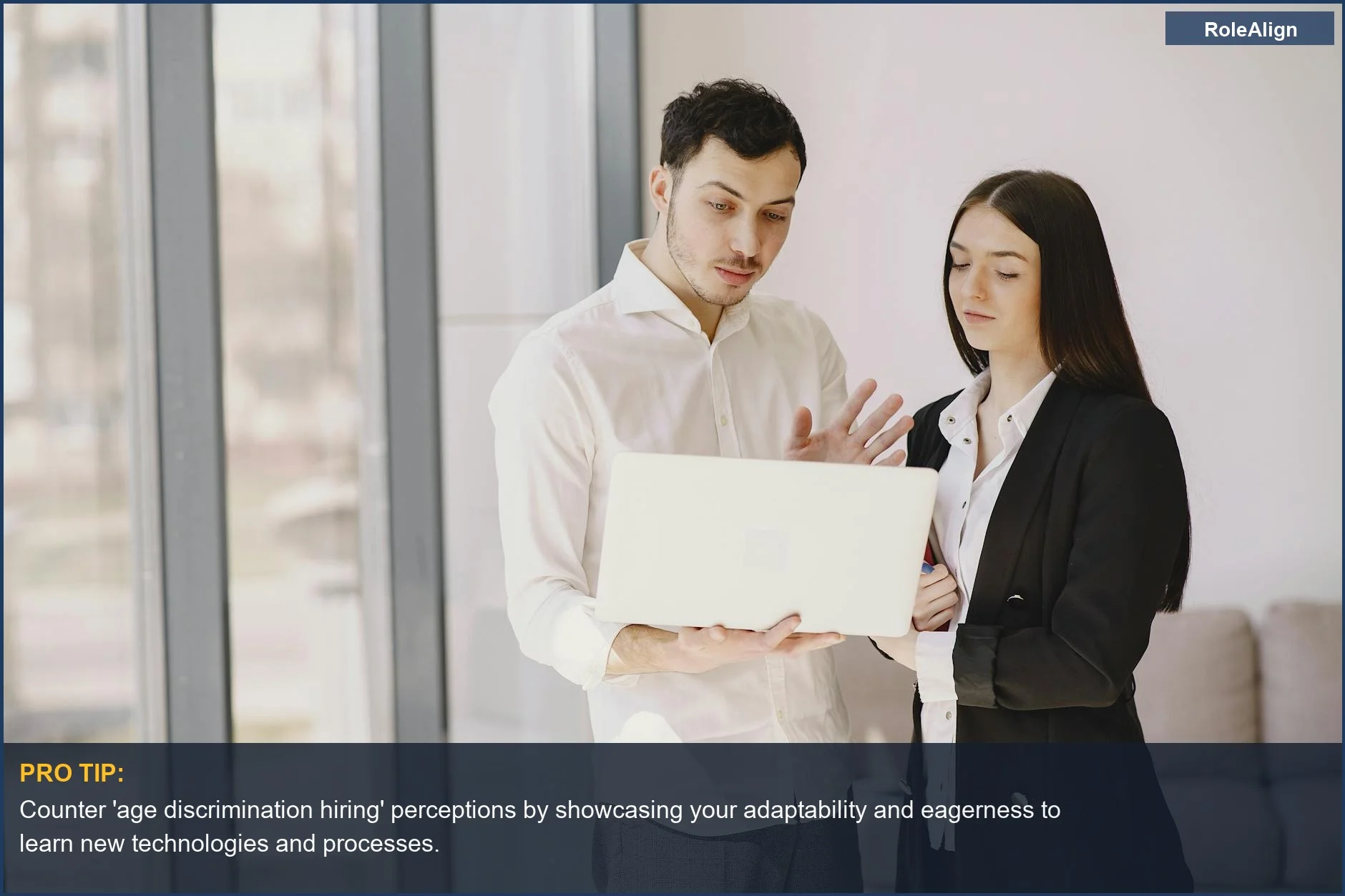 Young employee and colleague discuss work, highlighting the 'age discrimination hiring' aspect of perceived overqualification.