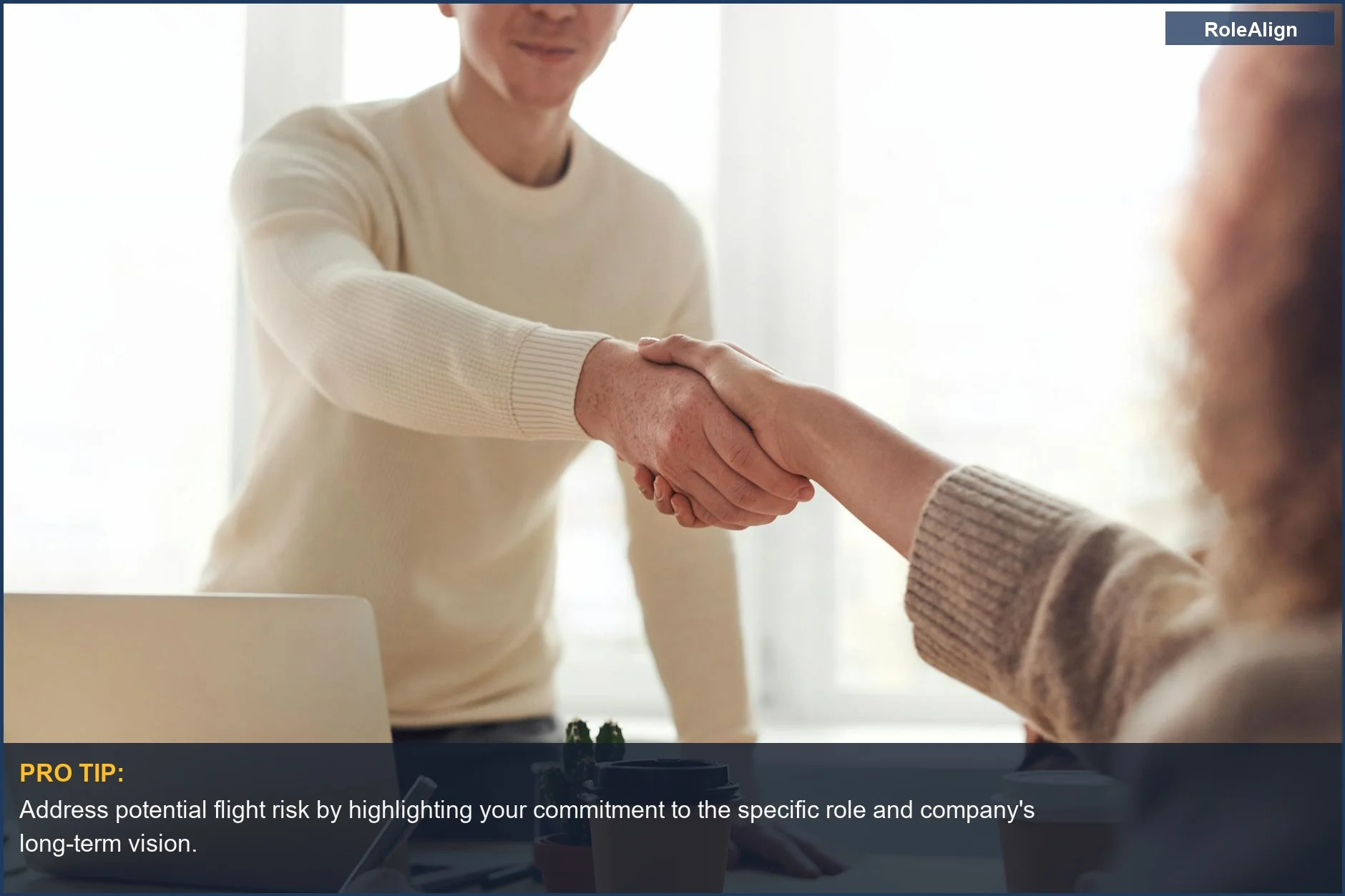 Professionals shaking hands, symbolizing the 'overqualified for job' rejection reason in a modern office.