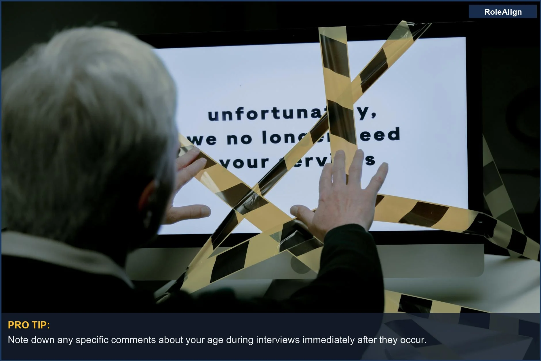 Elderly man reacts with dismay to a computer dismissal message, showing ageism and unemployment.