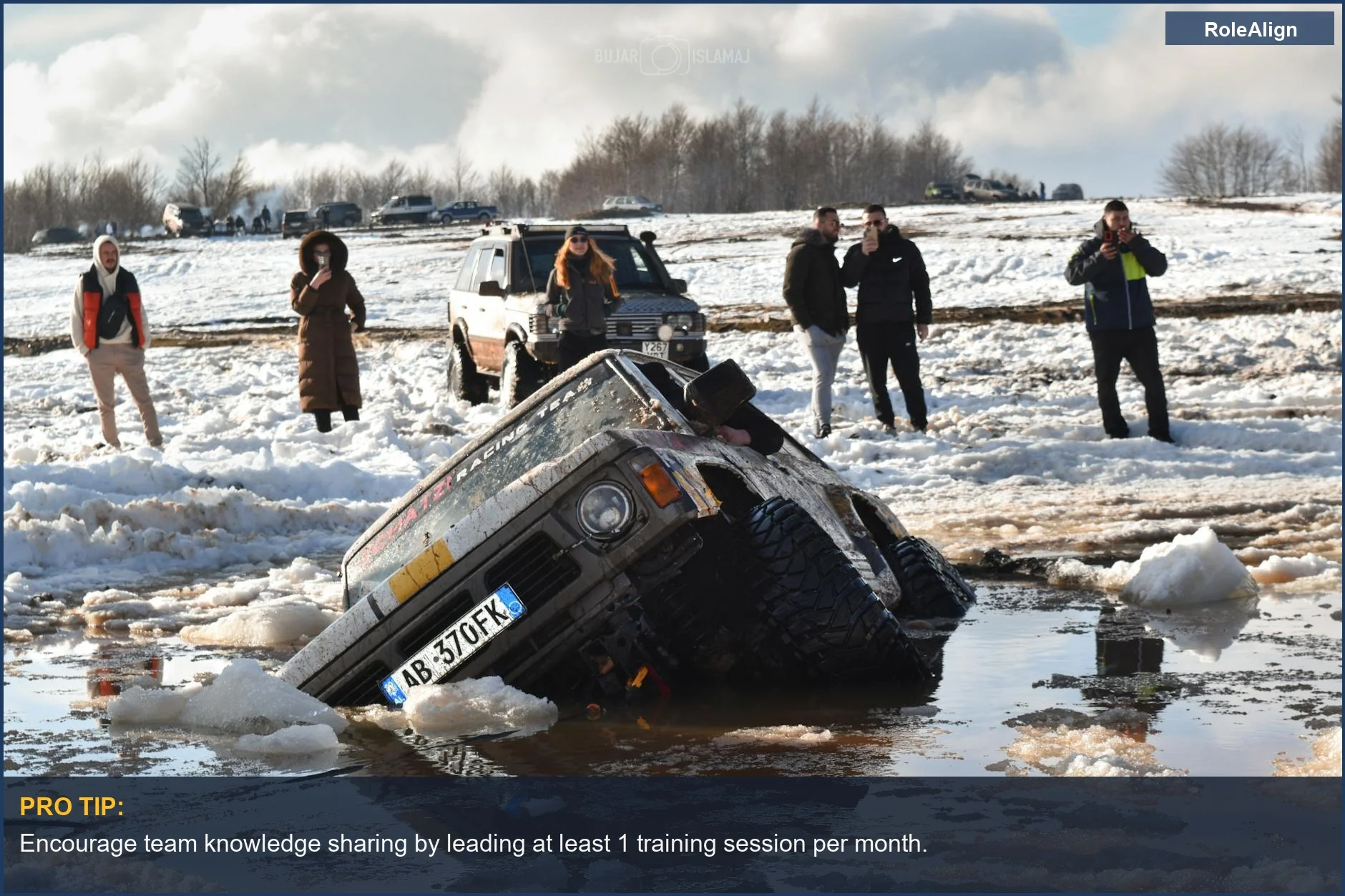 SUV stuck in mud and snow, representing an indispensable career trap and stalled professional growth.