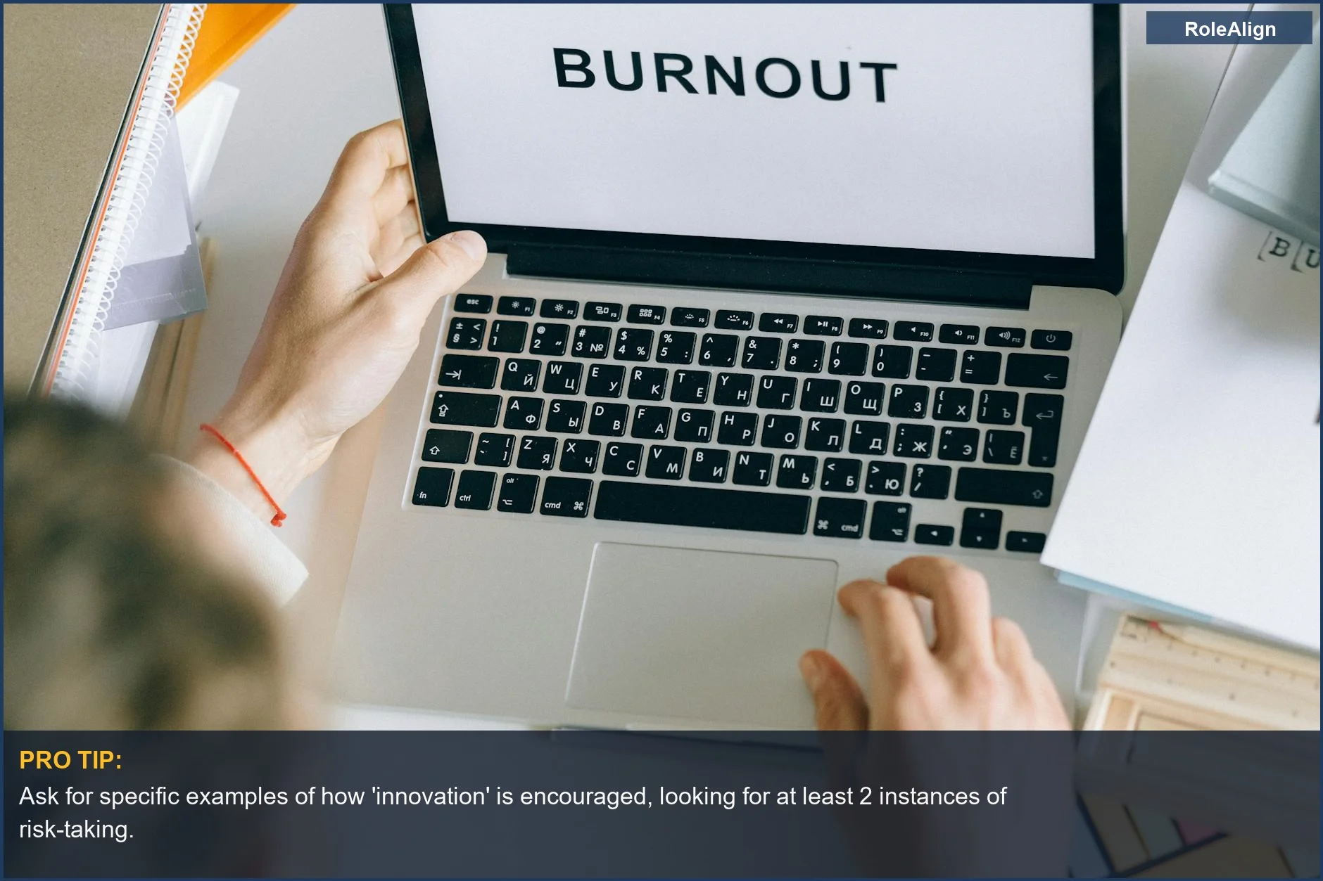 Person typing 'BURNOUT' on a laptop, symbolizing the impact of a negative company culture.