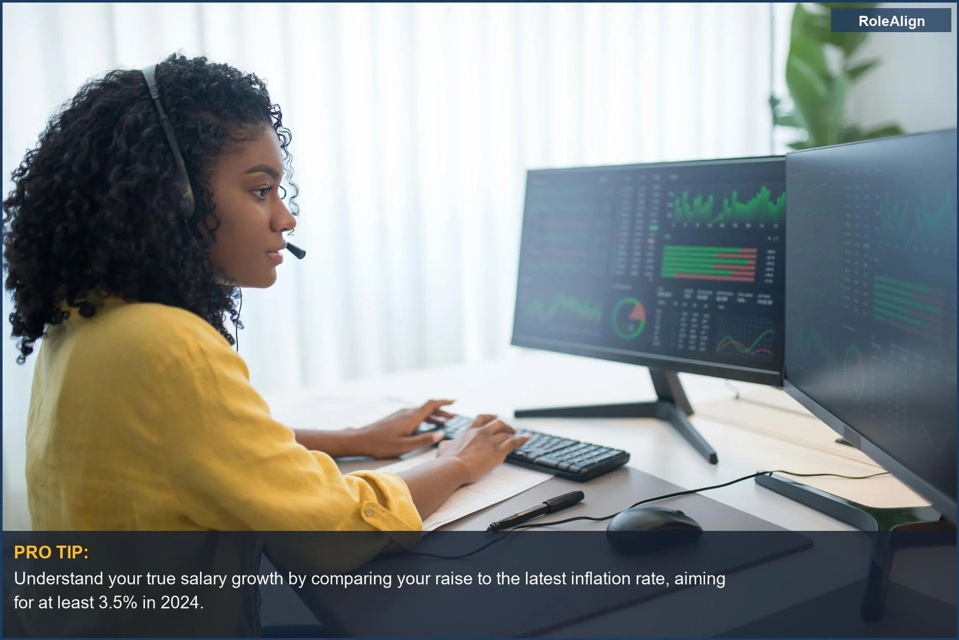 African American woman analyzing data on dual monitors, illustrating the impact of cost of living adjustments on real income.