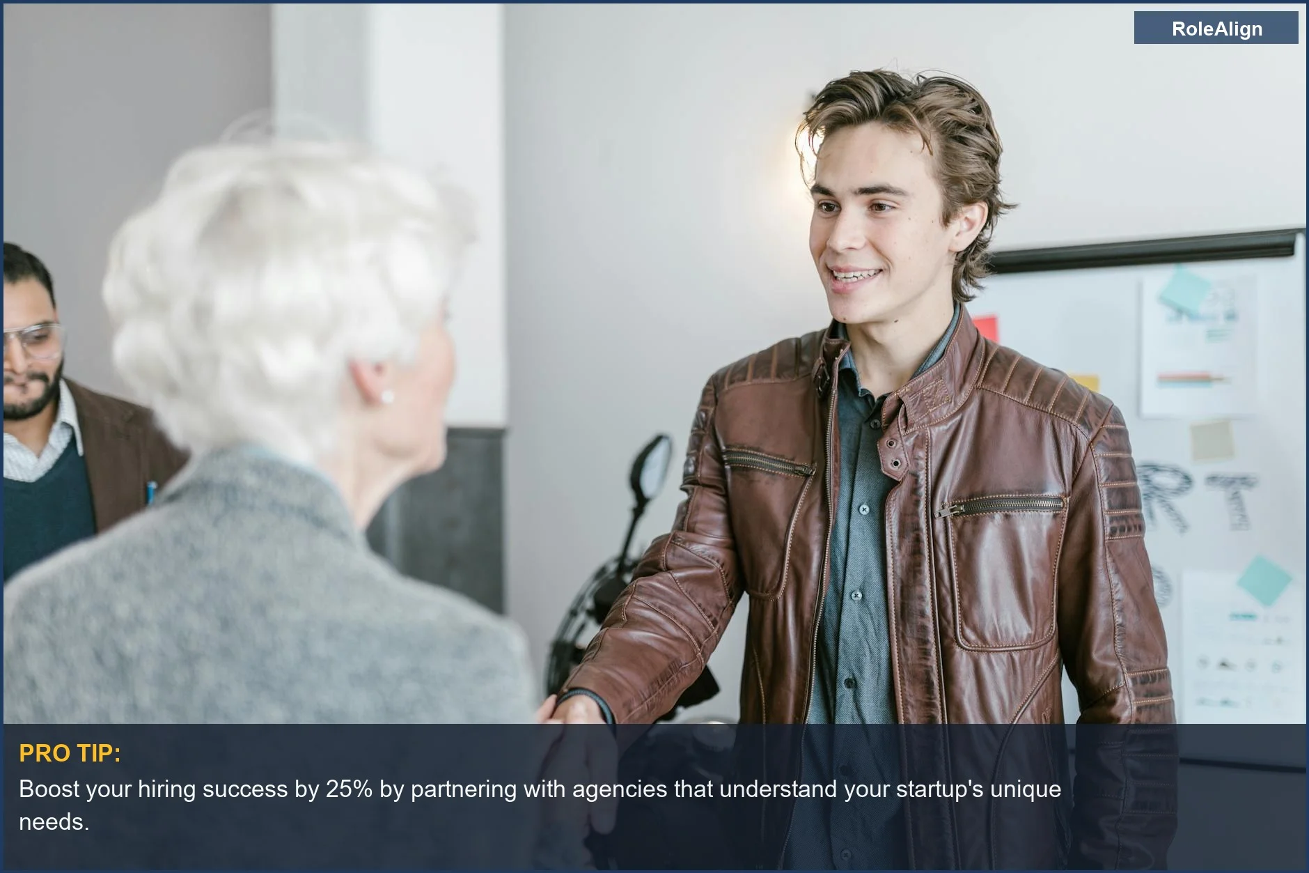 Young professionals shake hands, symbolizing the business collaboration and networking that explains why companies hire recruitment agencies.