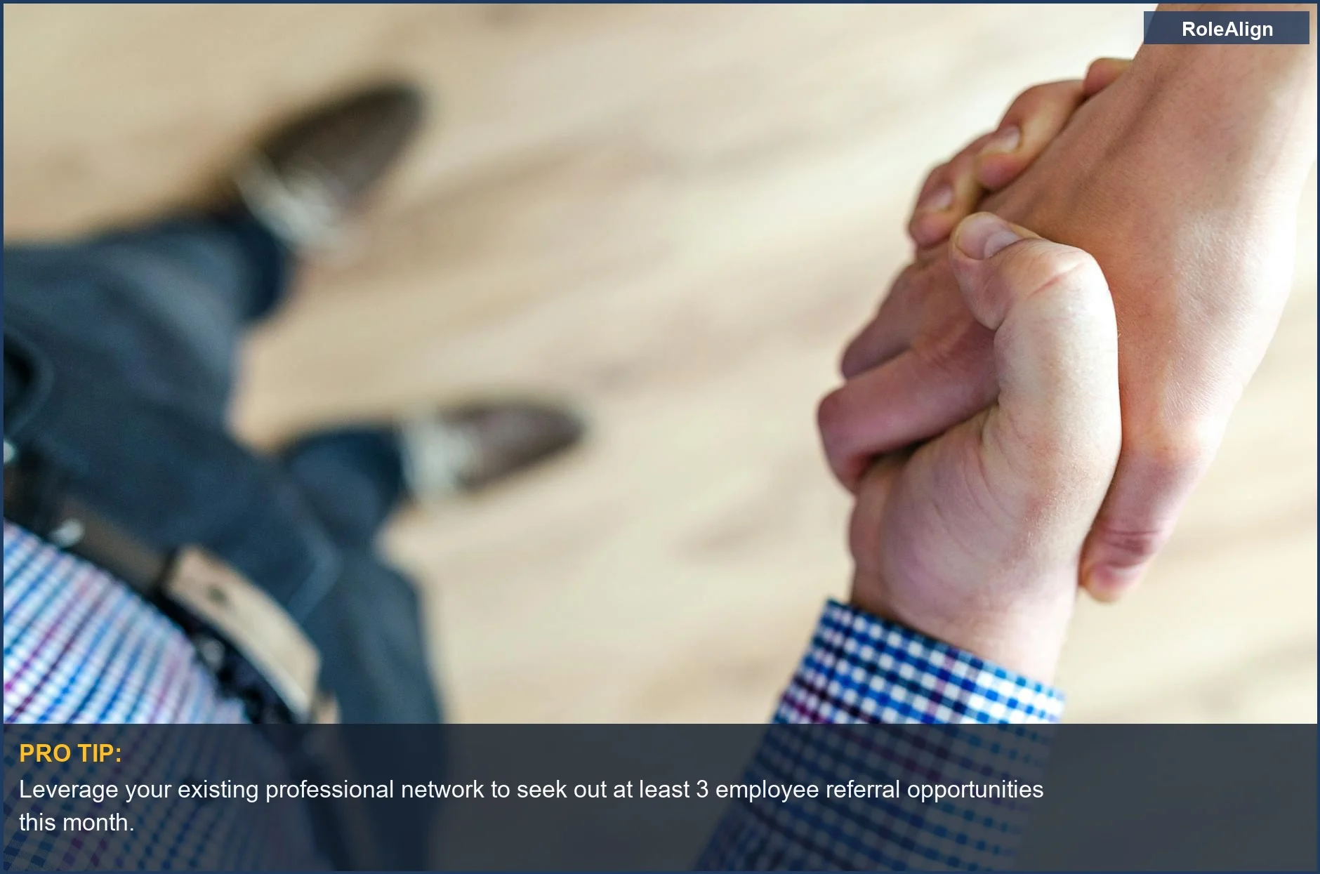 Two diverse professionals shaking hands in an office, illustrating the power of employee referral hiring in building trust.