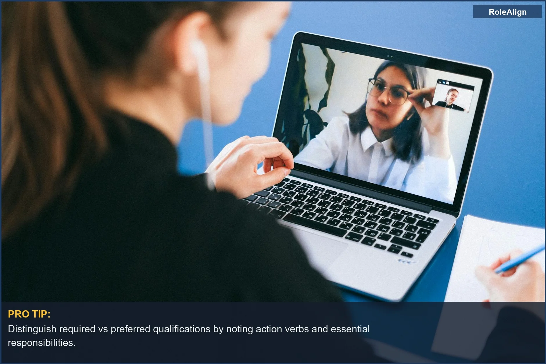Woman on a video conference call taking notes, showcasing required vs preferred qualifications job posting.