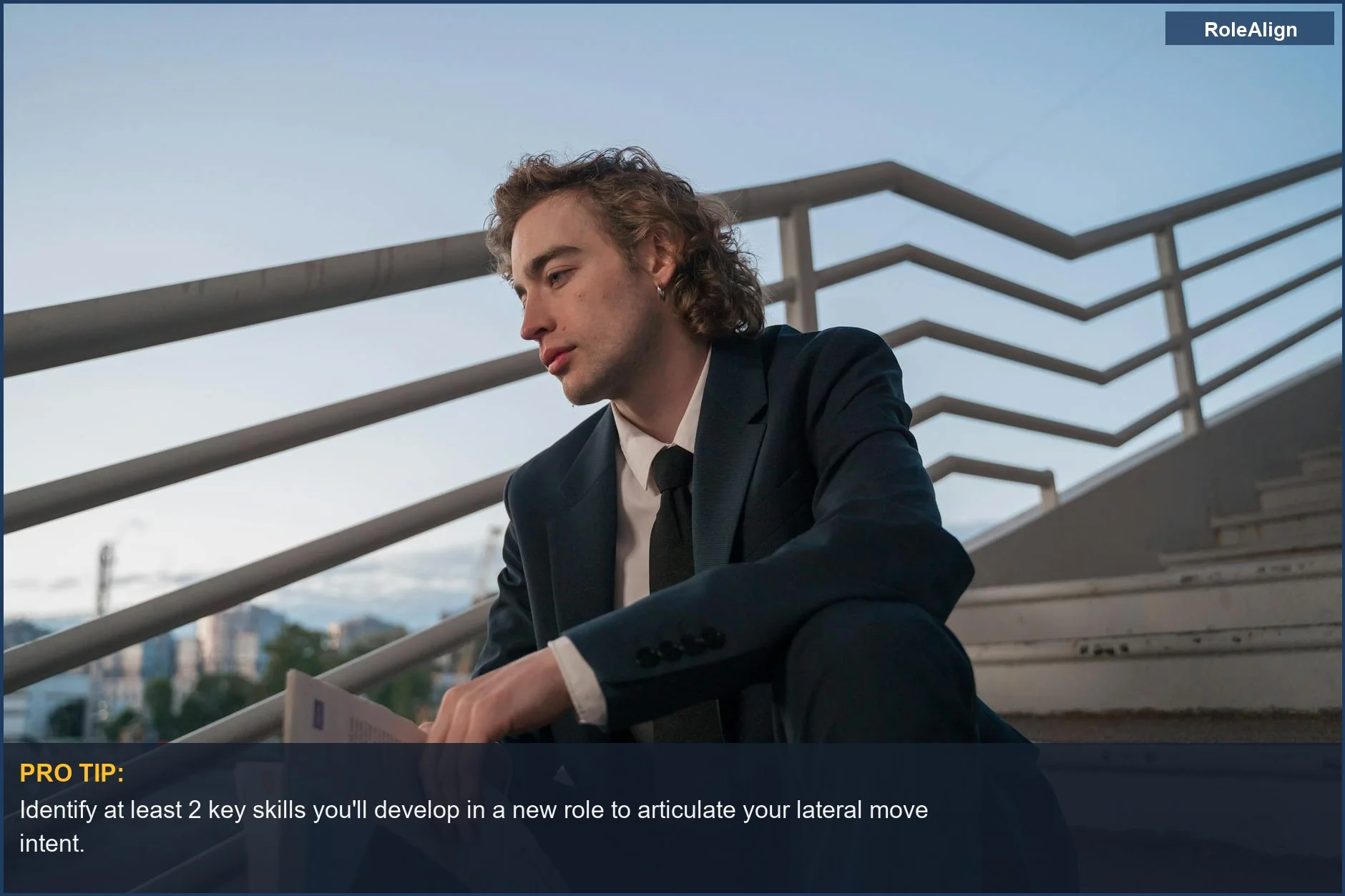 Thoughtful young man in suit on outdoor stairs, contemplating career decisions and lateral moves.