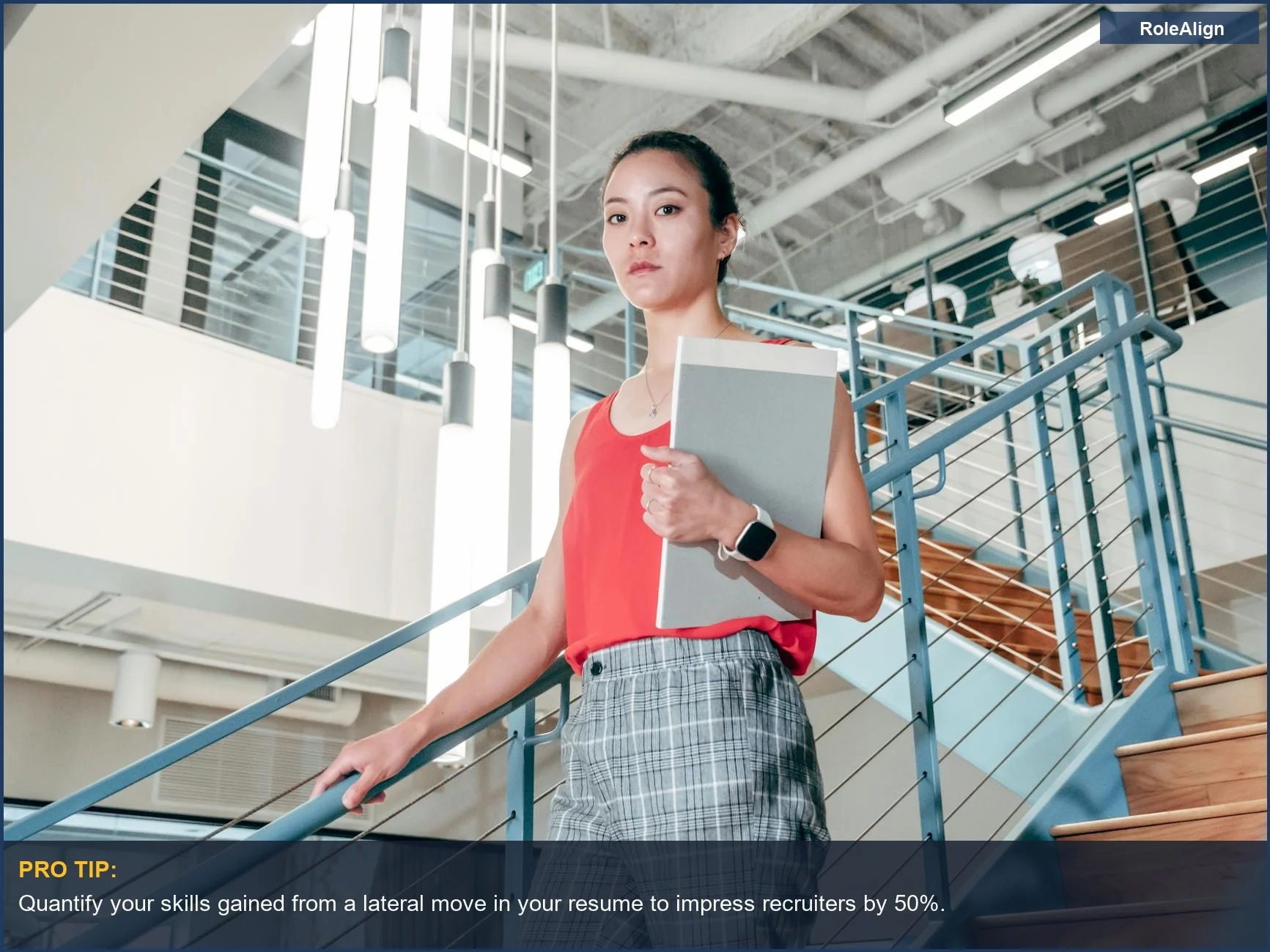Ambitious woman on modern office stairs with documents, achieving business success with a well-planned lateral vs promotion.