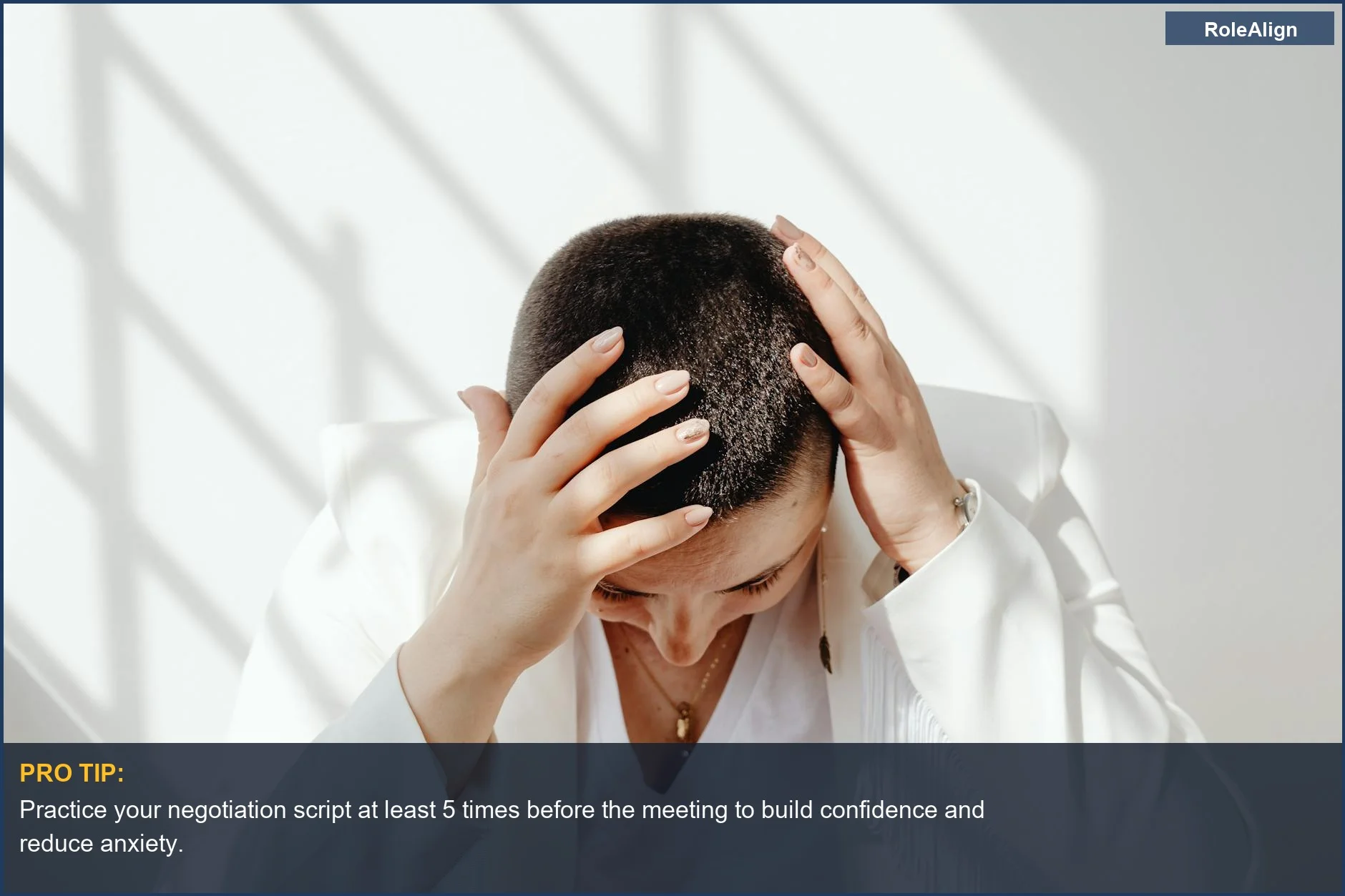 Woman stressed about salary negotiation, hands on head, highlighting why negotiation is scary.