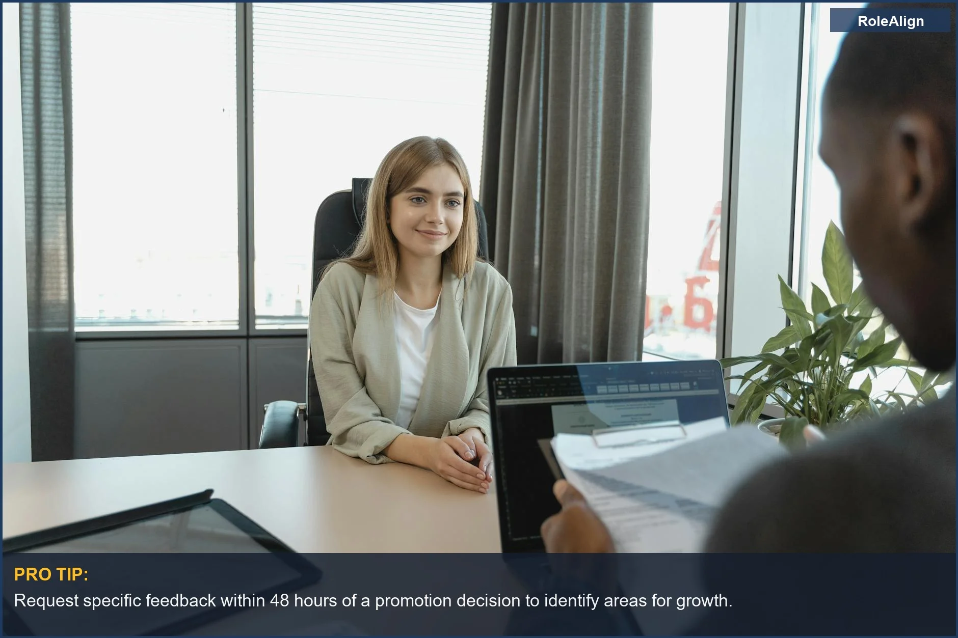 Confident young woman in a modern office setting for a job interview, emphasizing proactive feedback seeking after being passed over.
