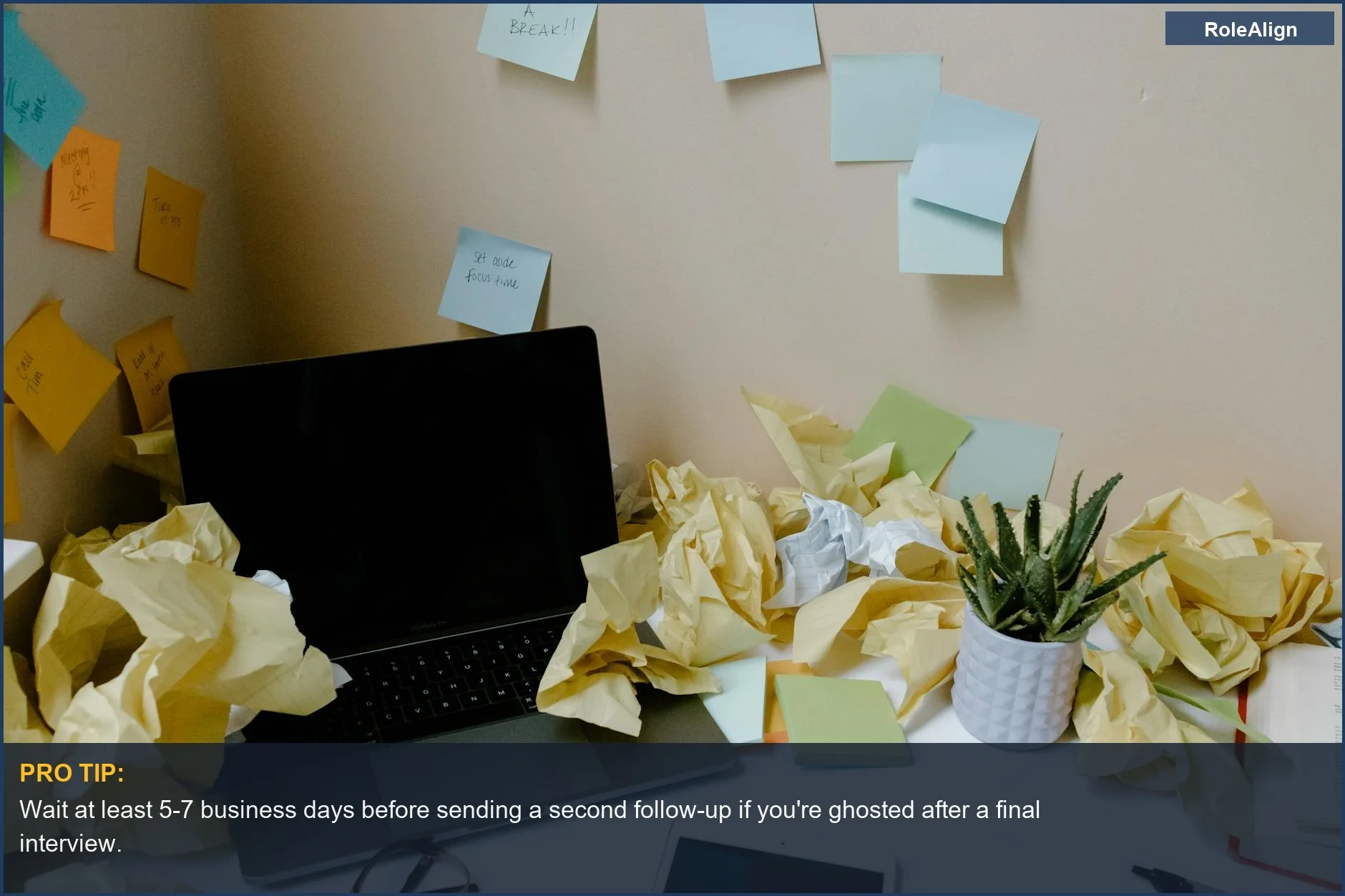Chaotic office desk with sticky notes shows the disorganization behind why no response is received after an interview.