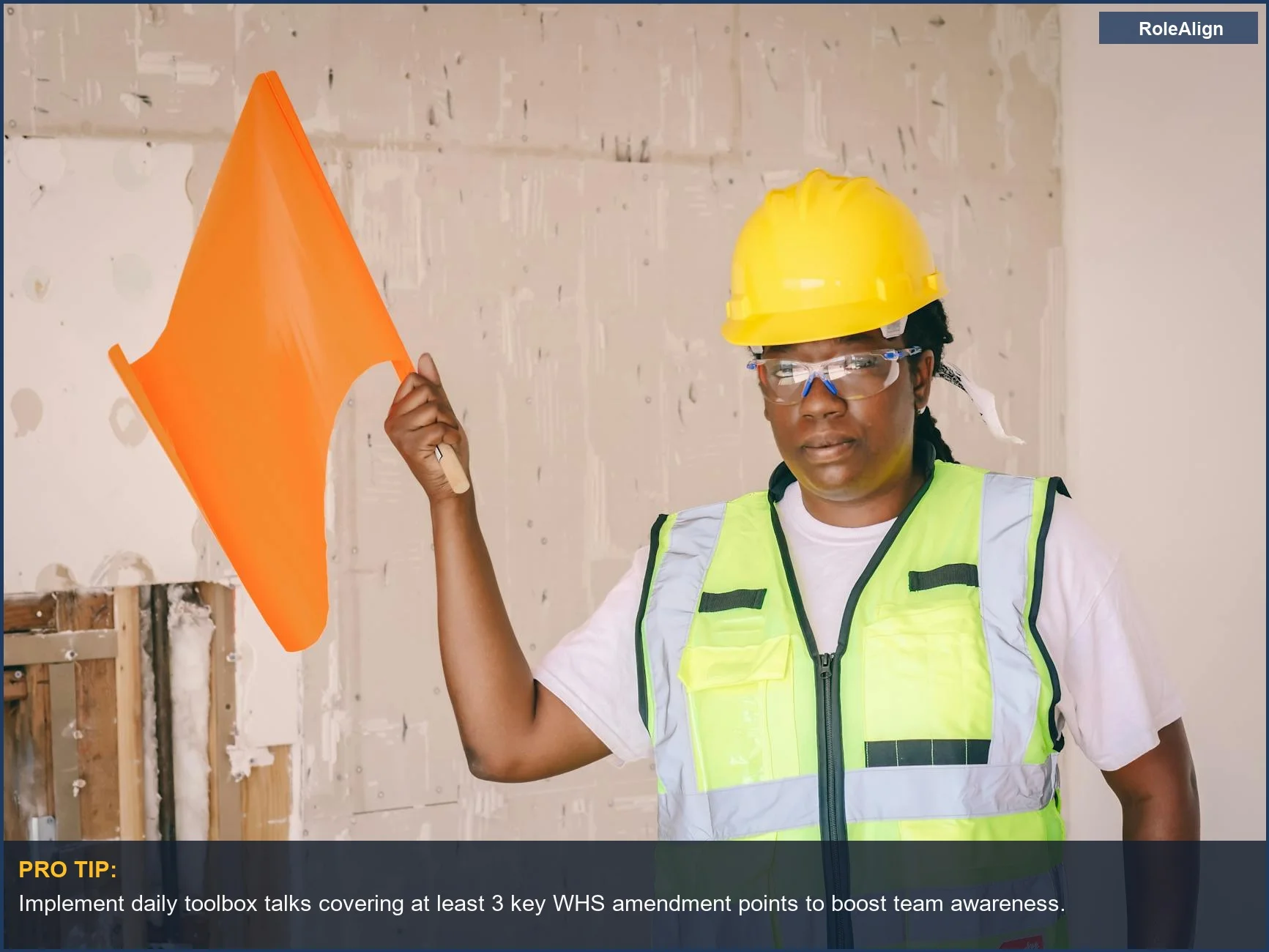 Female construction worker holding an orange flag demonstrates vigilance for occupational safety under new work health and safety amendments.