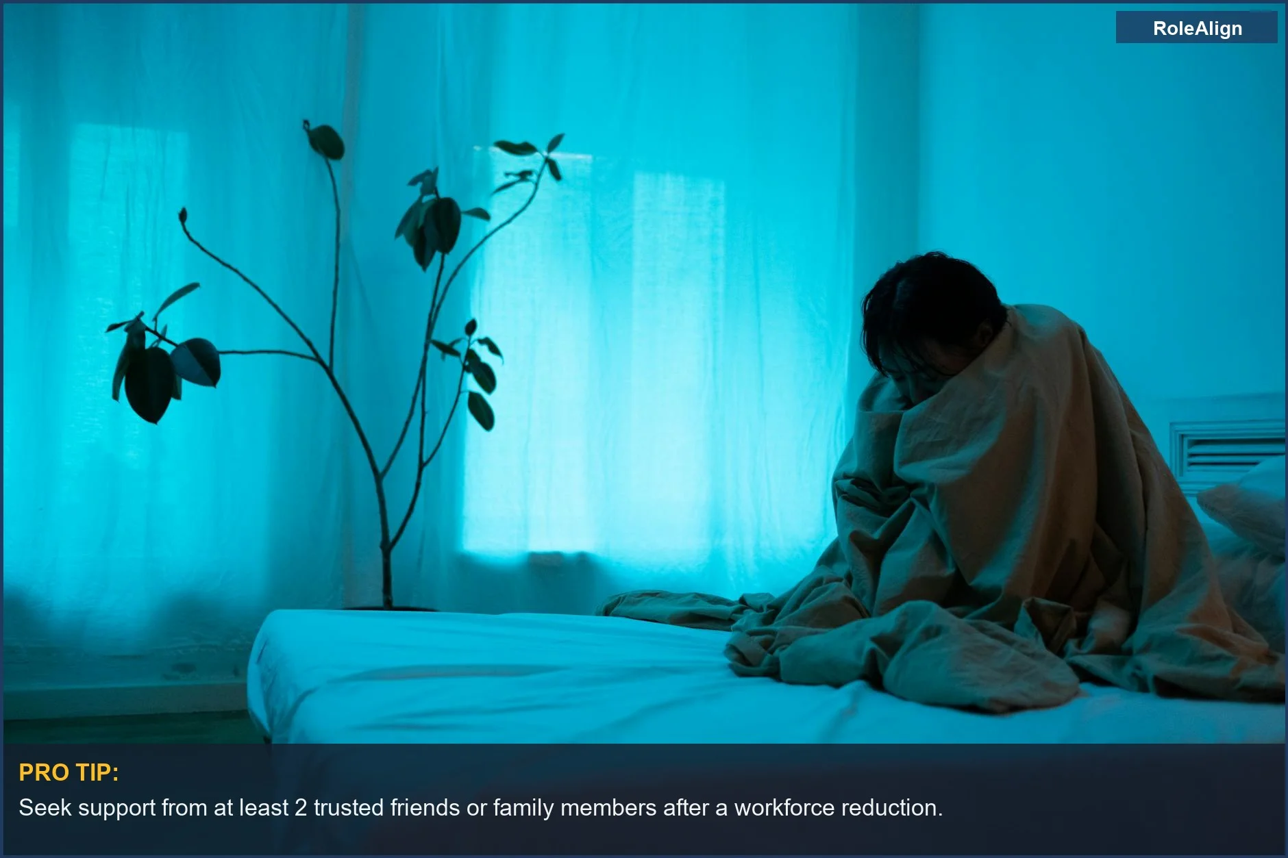 Woman wrapped in a blanket shows loneliness after a workforce reduction.