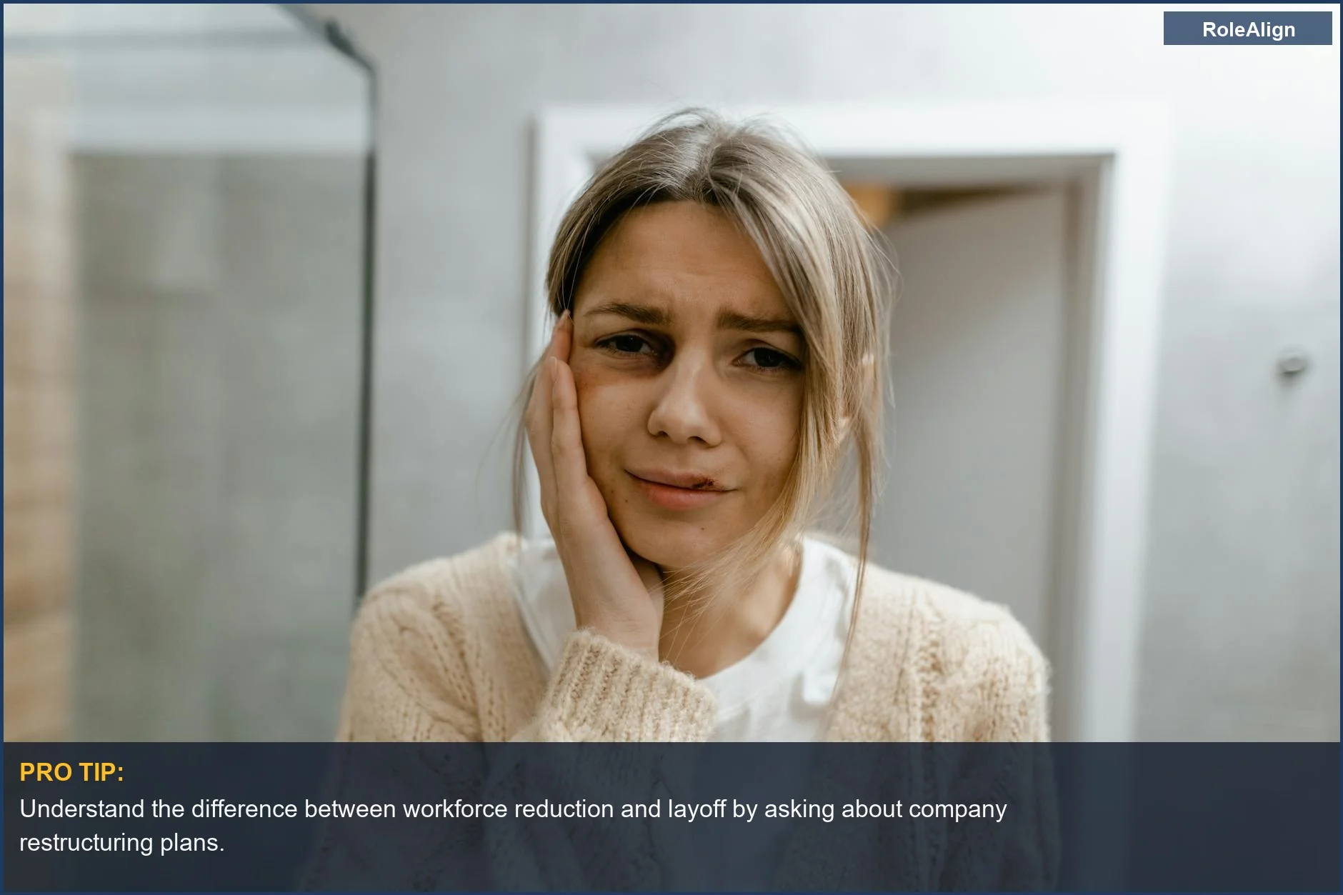 Worried woman's face shows distress during a workforce reduction announcement.